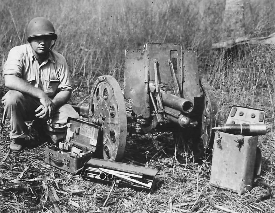 Marine_with_captured_Japanese_Type_92_Howitzer_Guadalcanal_1942.jpg